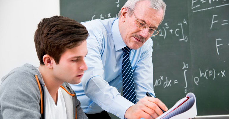 A teacher working through a problem with a student
